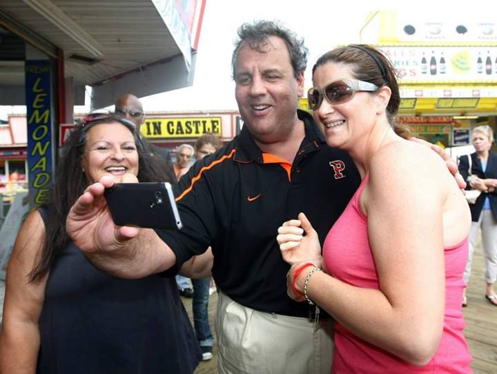 Governor Chris Christie takes a 'selfie' with Kate Silver of Toms River and Carla Heim of Brick while walking the area of the boardwalk that did not sustain fire damage